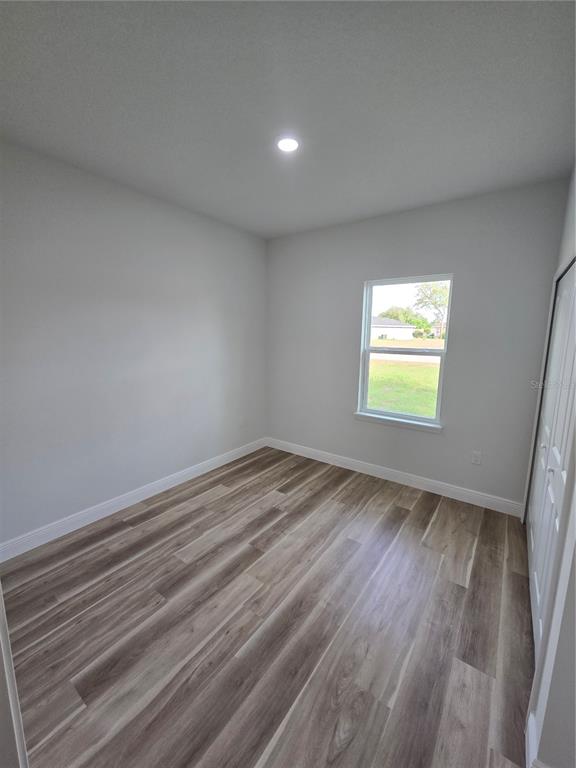 2717 Southwest 140th Loop Ocala, FL 34473 - Photo 32 of 40 a view of empty room with wooden floor and fan