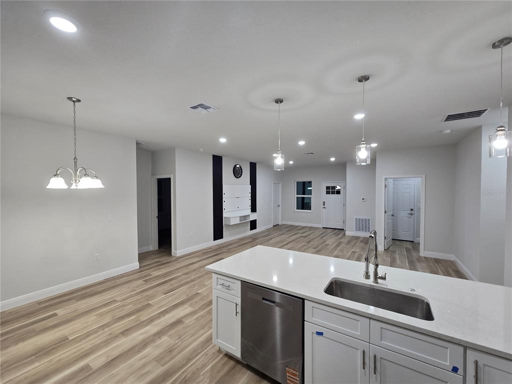 2717 Southwest 140th Loop Ocala, FL 34473 - Photo 5 of 40 a view of a kitchen island a sink and dishwasher with wooden floor