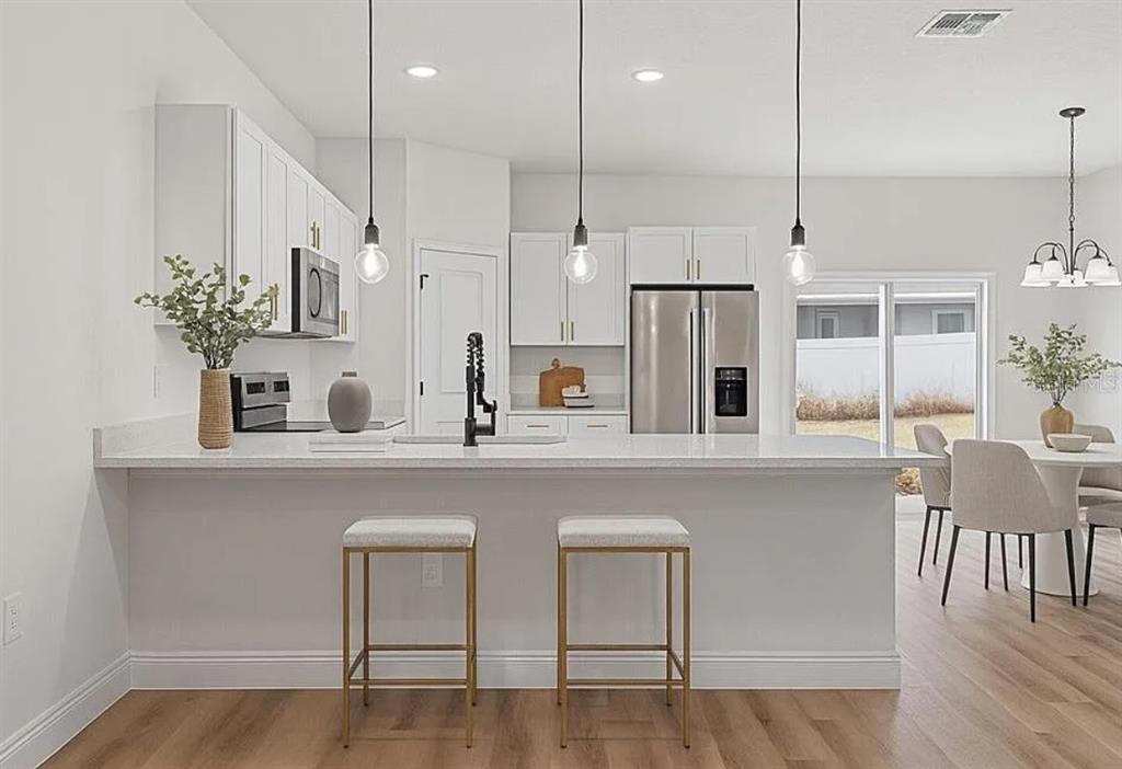 2717 Southwest 140th Loop Ocala, FL 34473 - Photo 8 of 40 a kitchen with cabinets and chairs