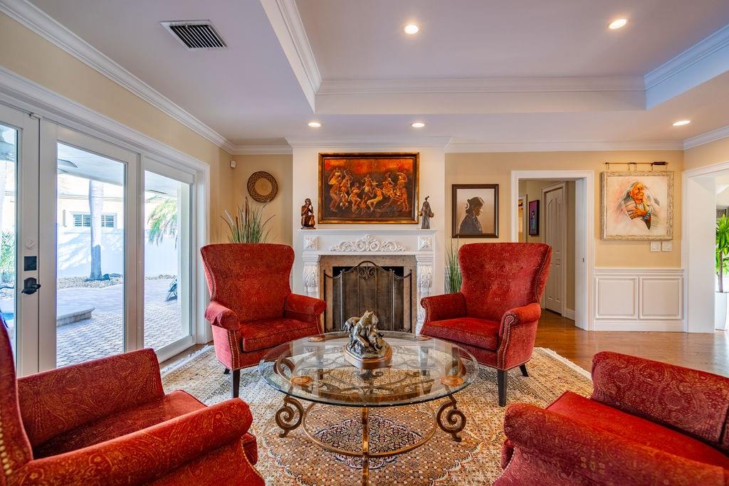 2317 Northeast 28th Court Lighthouse Point, FL 33064 - Photo 12 of 49 a living room with furniture a fireplace and a flat screen tv