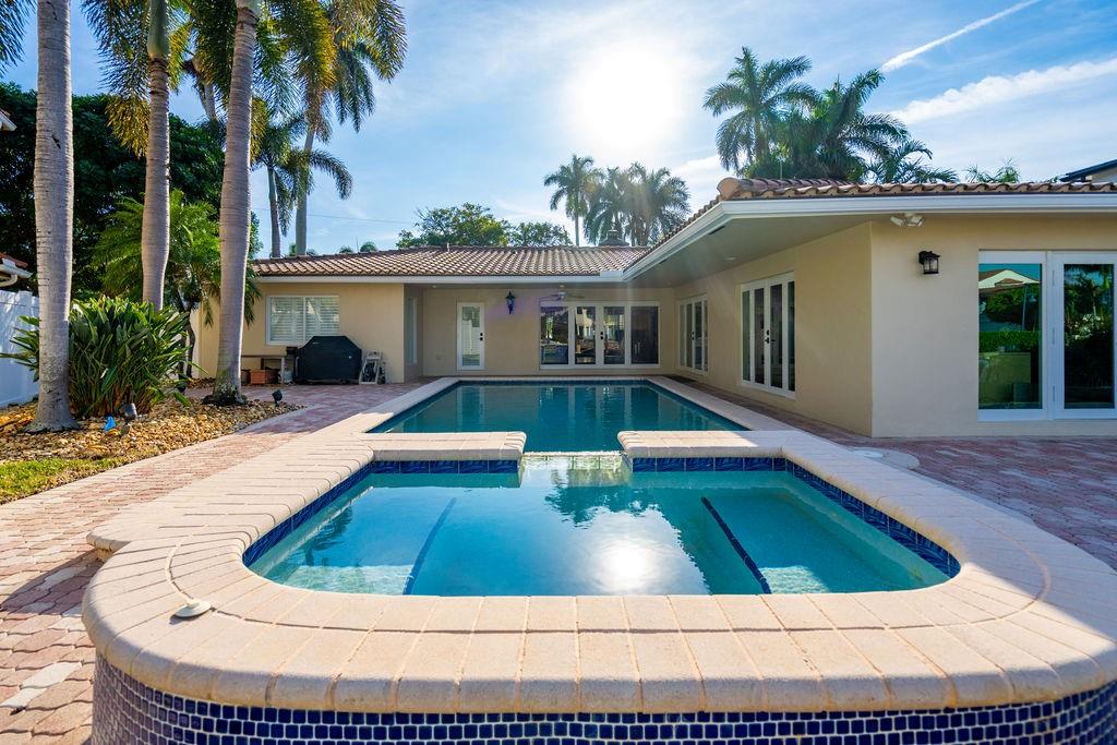 2317 Northeast 28th Court Lighthouse Point, FL 33064 - Photo 33 of 49 a view of swimming pool with outdoor seating