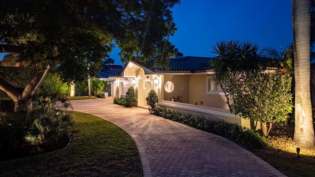 2317 Northeast 28th Court Lighthouse Point, FL 33064 - Photo 5 of 49 a front view of a house with a yard