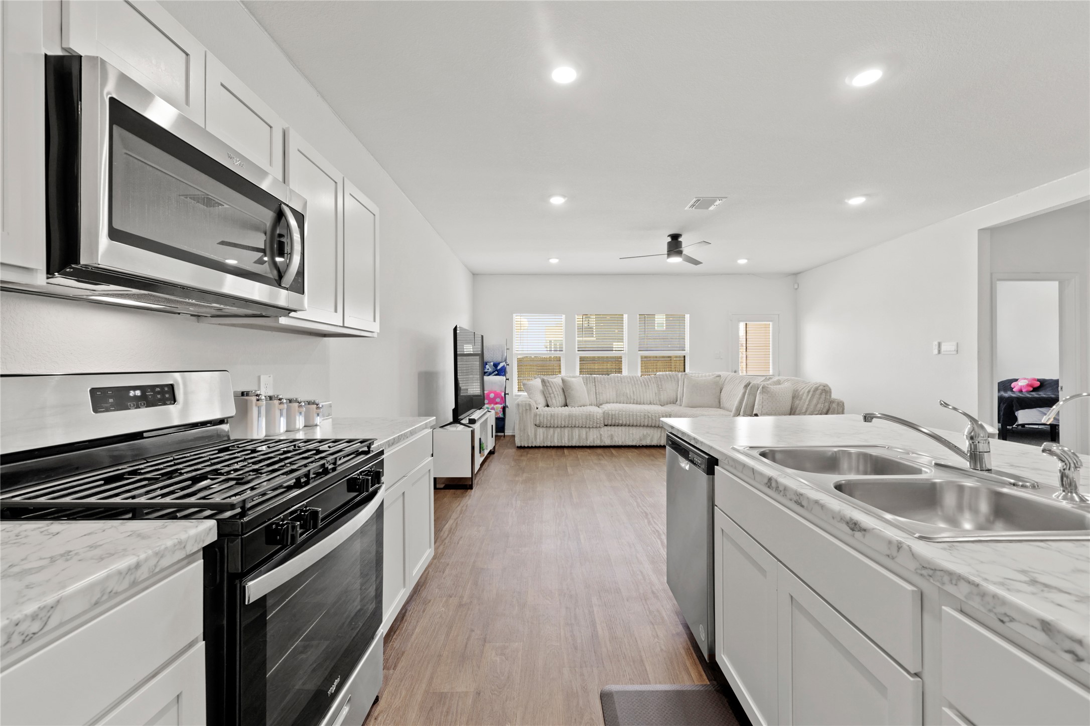 790 Arnold Loop Kyle, TX 78640 - Photo 11 of 36 Chef’s Corner! This high-energy cooking station features a sleek gas range, a powerful built-in microwave, and crisp white cabinetry that keeps all your gourmet tools right at your fingertips.