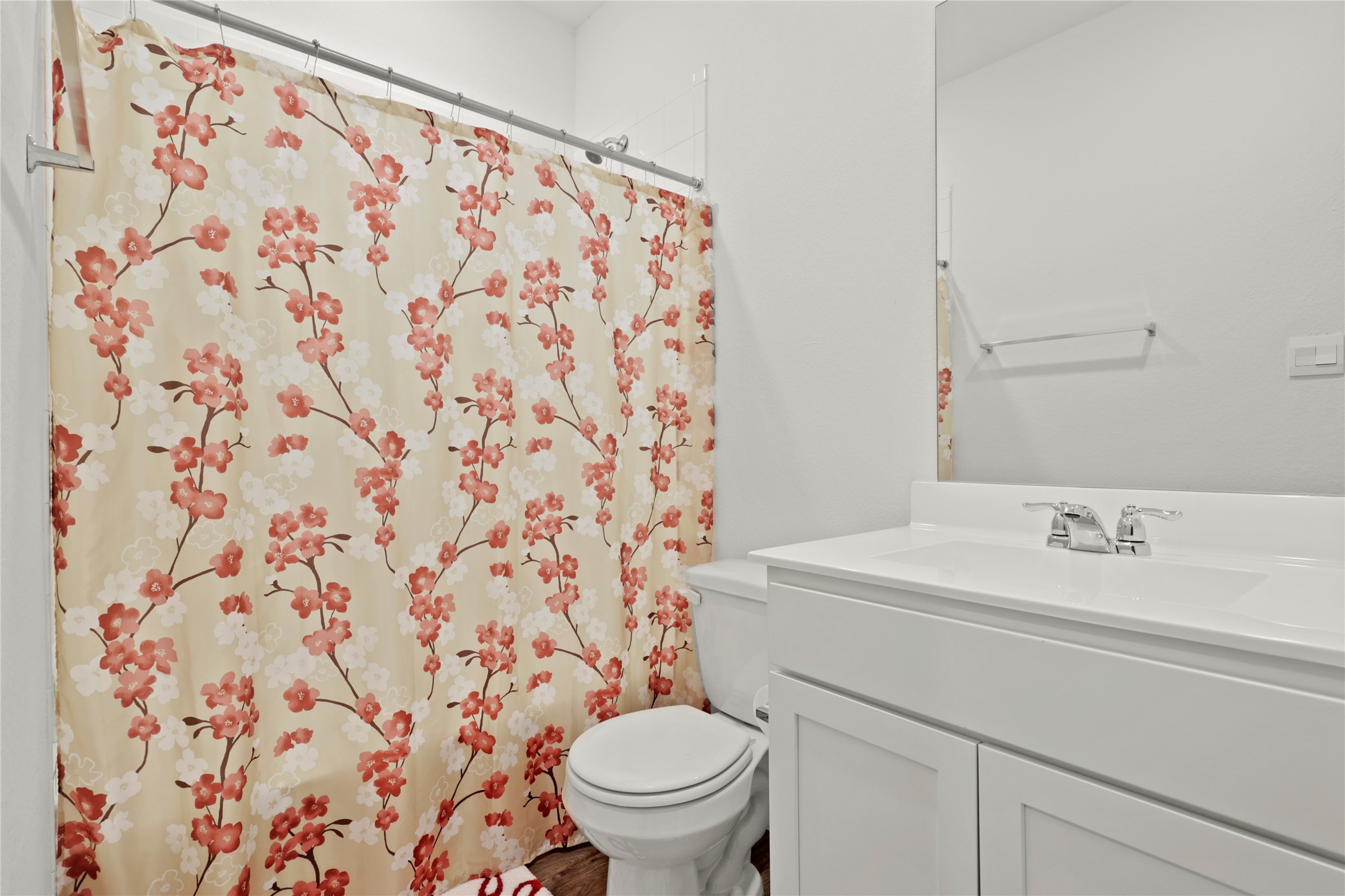 790 Arnold Loop Kyle, TX 78640 - Photo 22 of 36 A clean and simple guest bath, conveniently located off the main foyer and featuring a crisp white vanity and modern wood-style flooring.