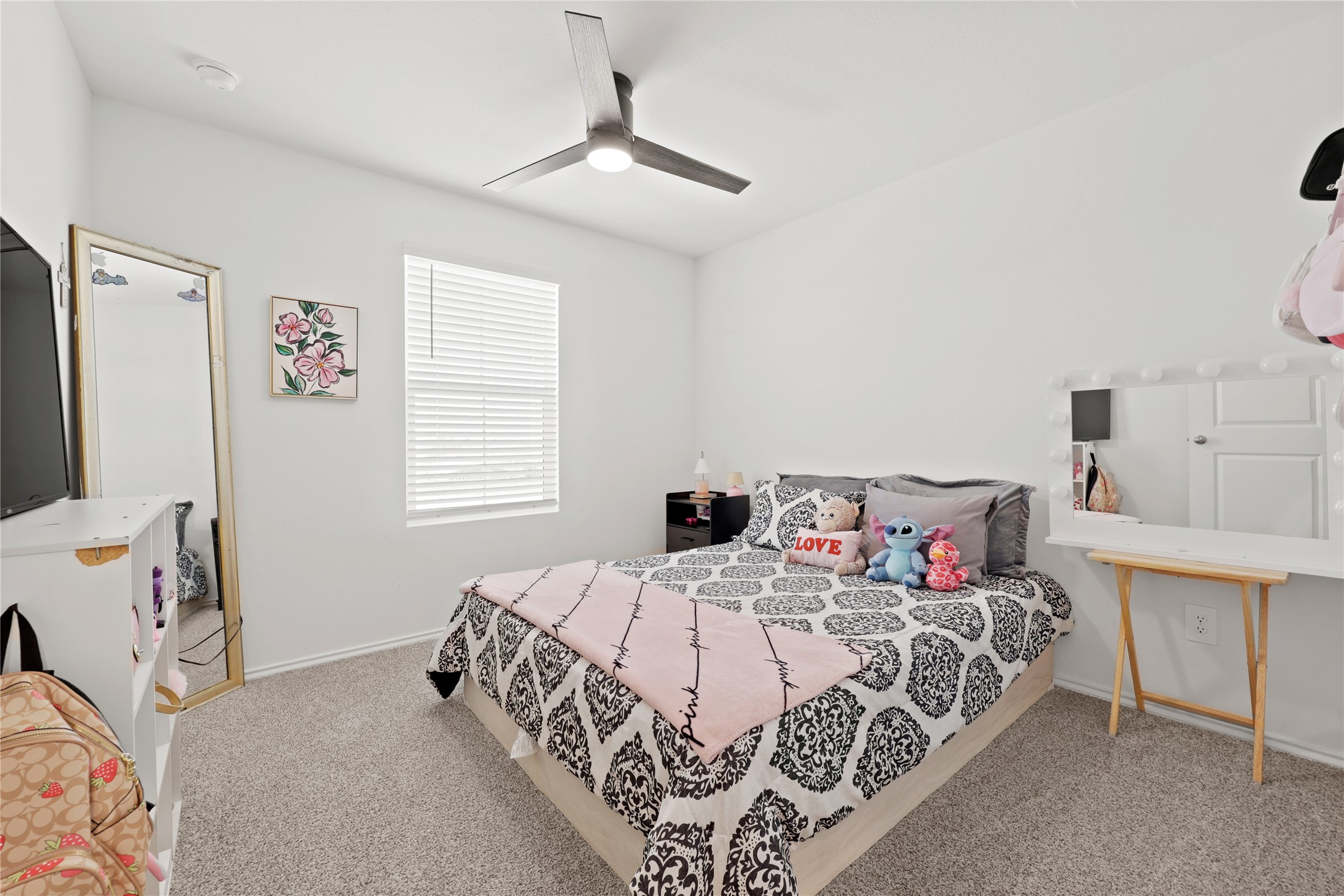 790 Arnold Loop Kyle, TX 78640 - Photo 25 of 36 This spacious upstairs bedroom features plush carpeting, a modern ceiling fan, and a window that keeps the space feeling bright and airy.