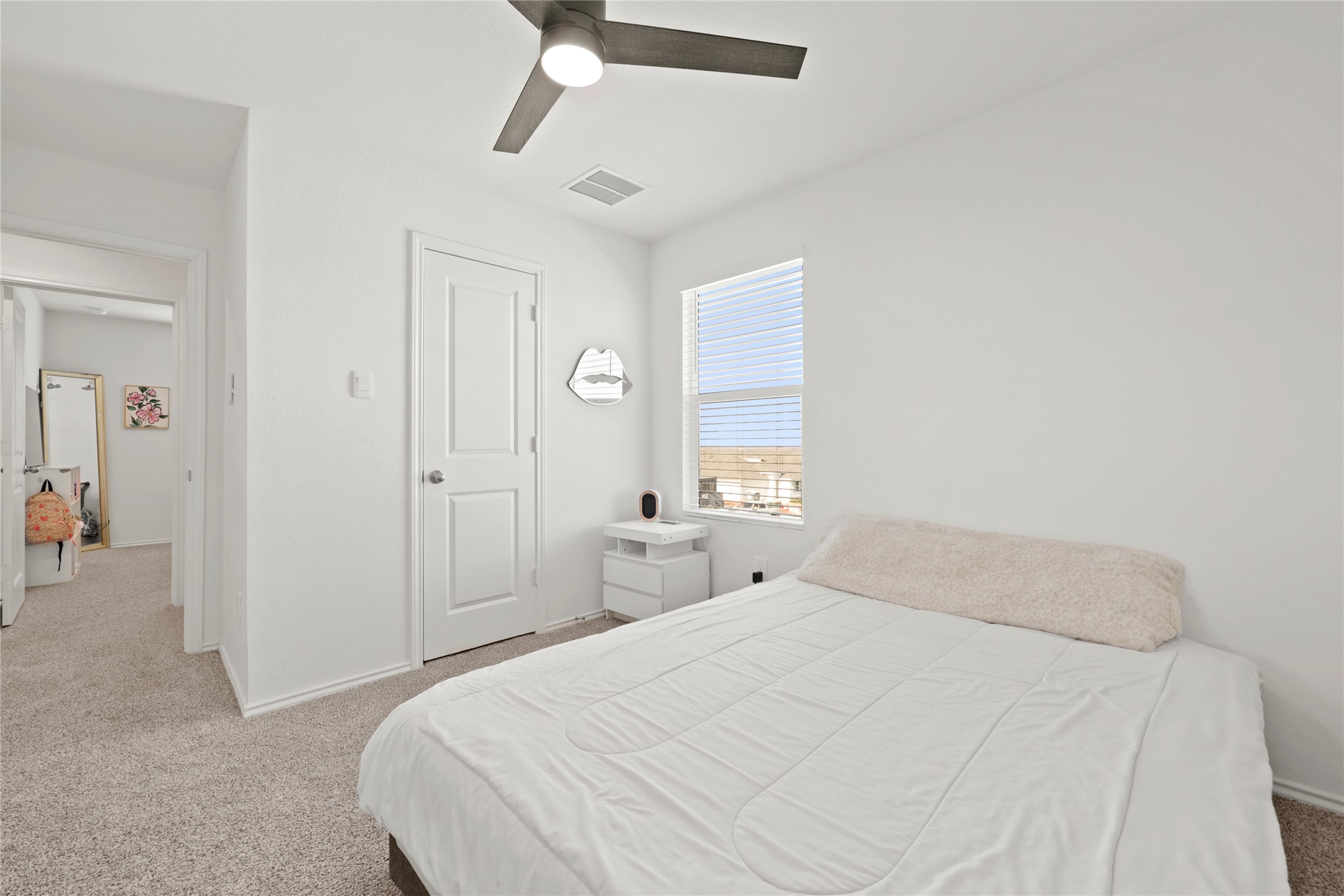 790 Arnold Loop Kyle, TX 78640 - Photo 29 of 36 Comfortable upstairs bedroom boasts clean lines, a cooling ceiling fan, and a large window overlooking the neighborhood.
