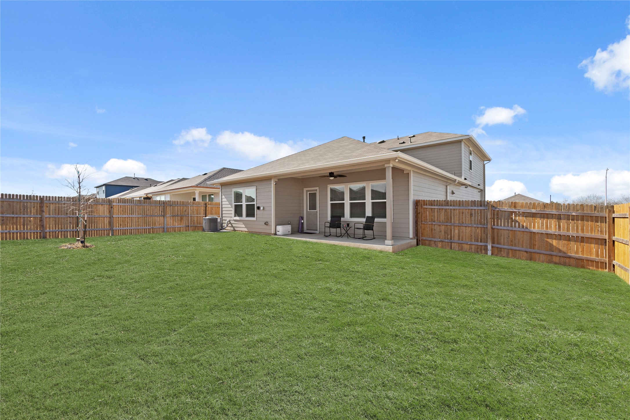 790 Arnold Loop Kyle, TX 78640 - Photo 30 of 36 Your private outdoor oasis awaits! This massive, lush backyard is fully enclosed by a privacy fence and features a covered patio, making it the perfect spot for weekend BBQs or quiet morning coffee.