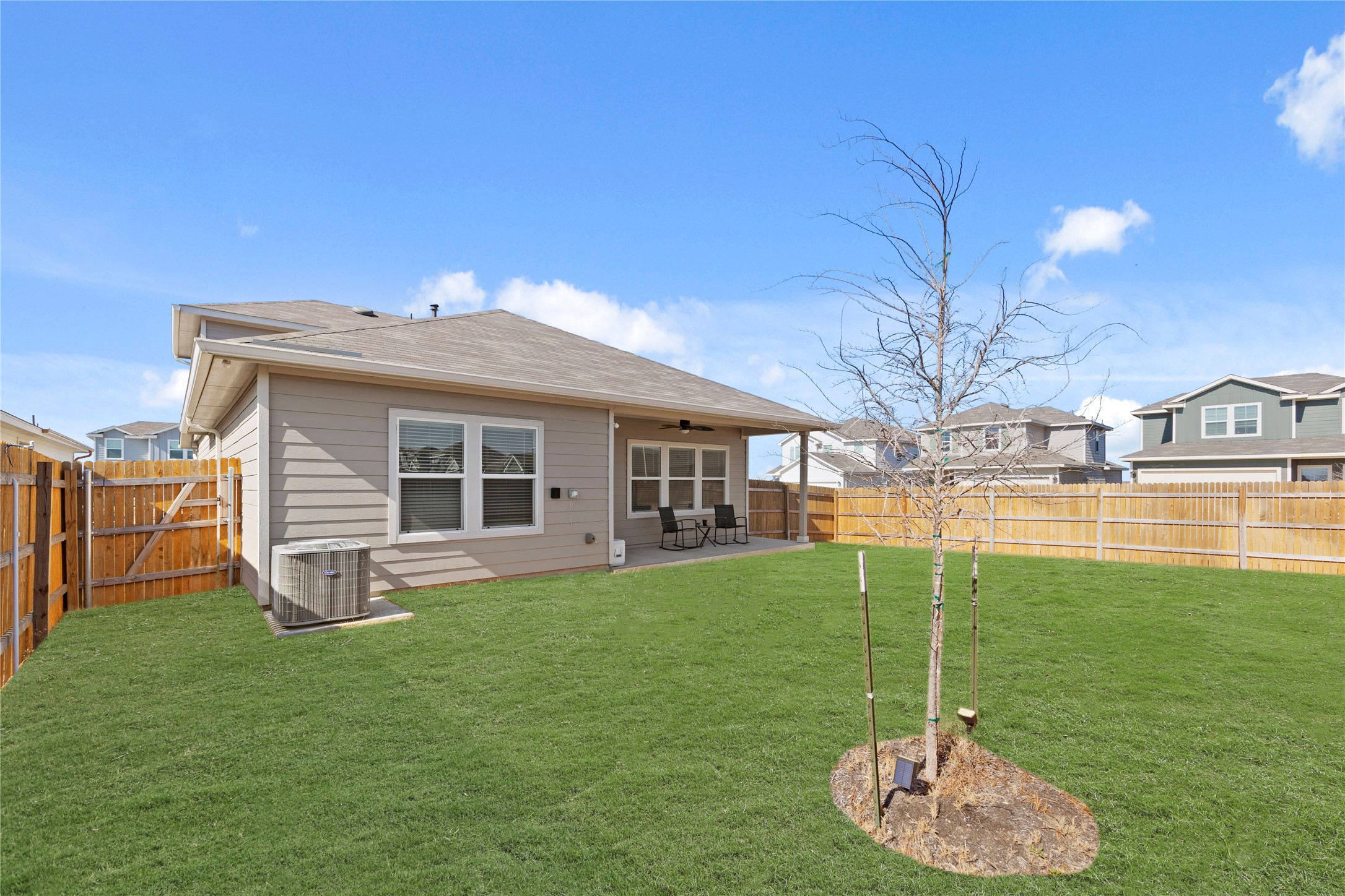 790 Arnold Loop Kyle, TX 78640 - Photo 32 of 36 The perfect extension of home. Enjoy seamless indoor-outdoor living with a spacious covered porch that overlooks a meticulously maintained yard, offering plenty of room for people and gatherings.