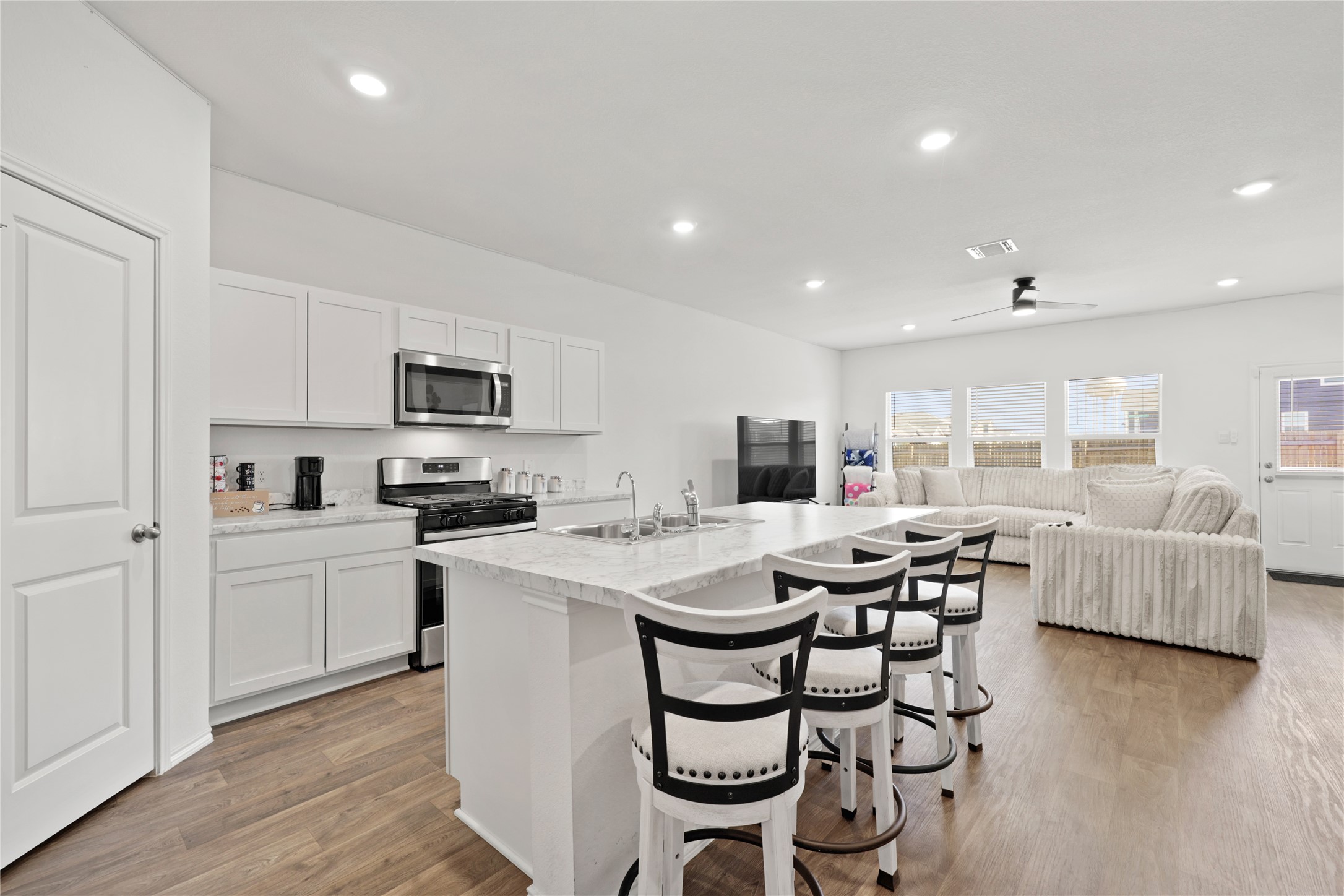 790 Arnold Loop Kyle, TX 78640 - Photo 8 of 36 A view that inspires! This chef-inspired kitchen overlooks the entire main floor, giving you a perfect line of sight through the living room to the bright windows and the backyard beyond.