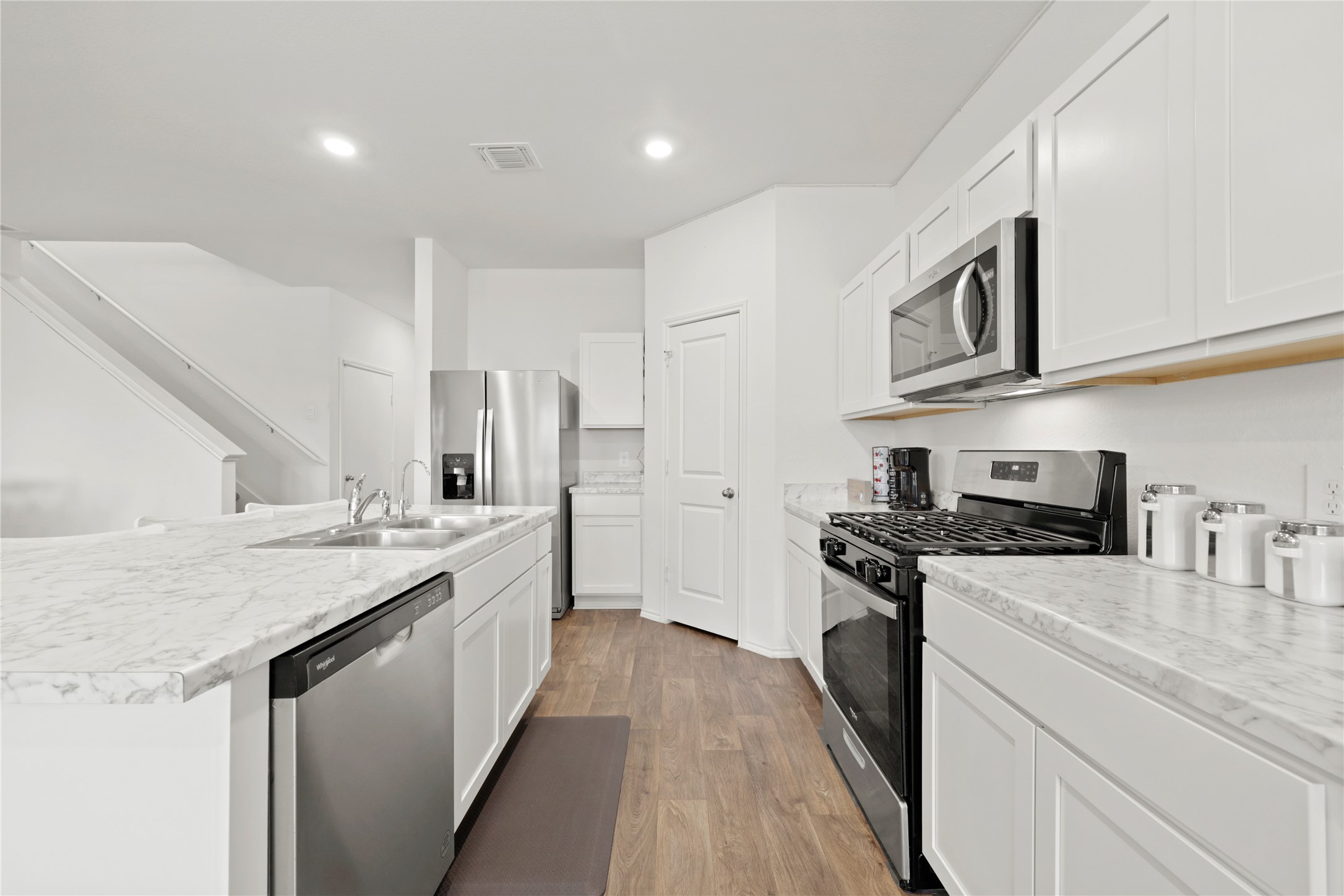 790 Arnold Loop Kyle, TX 78640 - Photo 10 of 36 The ultimate command center! With its sleek stainless steel appliances, crisp white cabinetry, and massive prep island, this kitchen is as functional as it is beautiful.