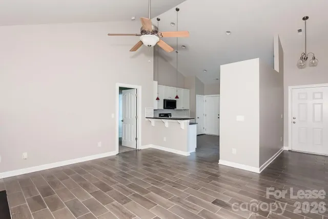 a view of a kitchen with wooden floor and a kitchen