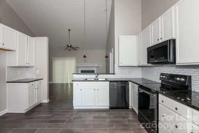 a kitchen with stainless steel appliances a stove sink microwave and cabinets