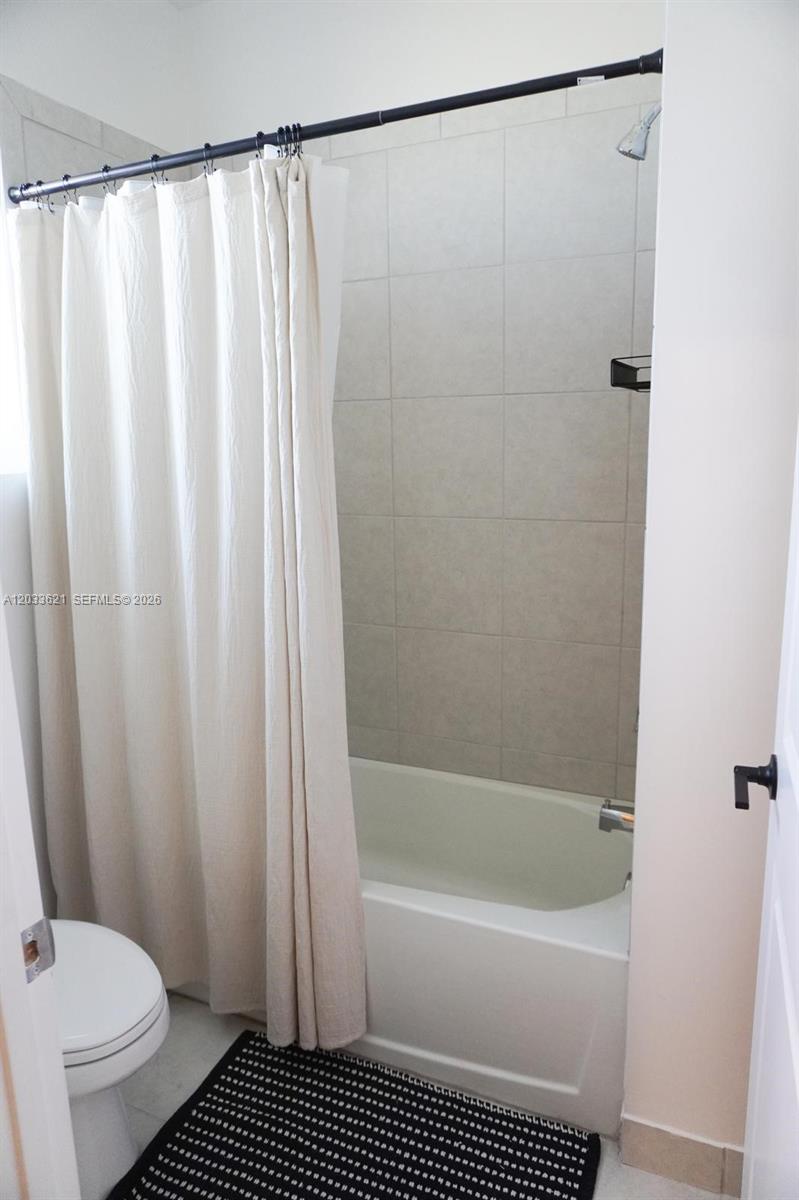 11942 Southwest 243rd Street Homestead, FL 33032 - Photo 31 of 50 a bathroom with a sink a toilet and a bathtub