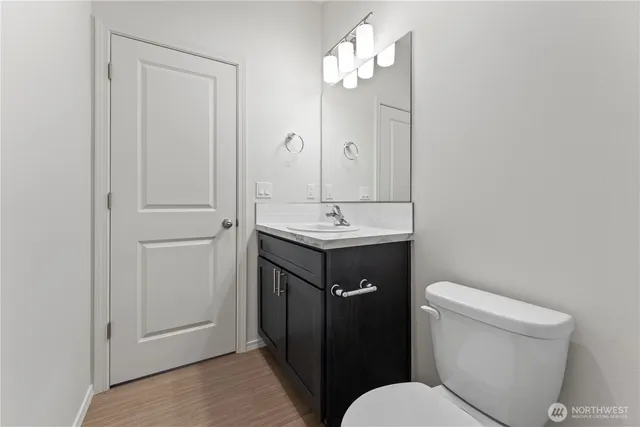 a bathroom with a toilet sink and mirror