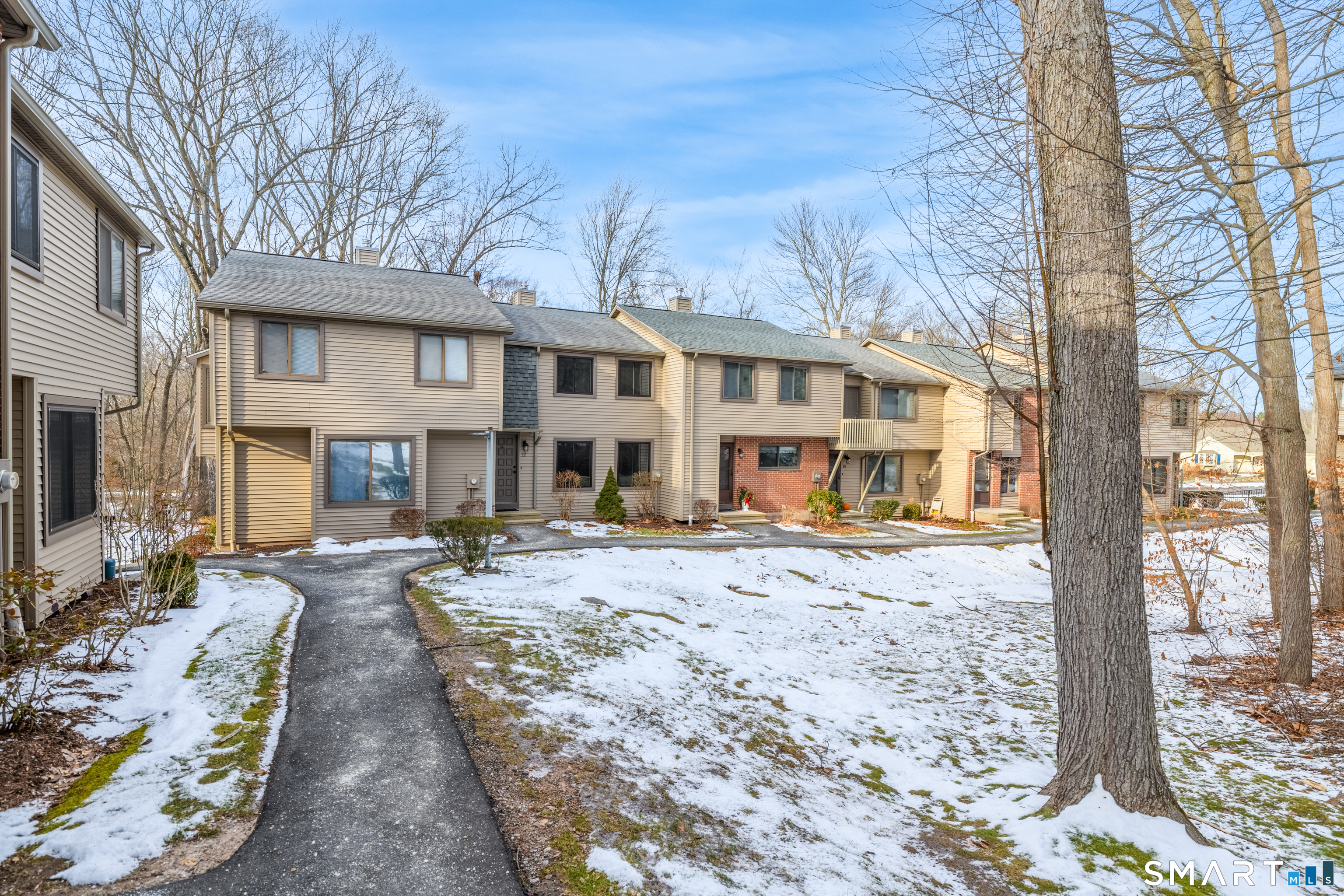 32 Conestoga Way, Unit 32 Glastonbury, CT 06033 - Photo 4 of 38 a front view of a house with yard patio and fire pit
