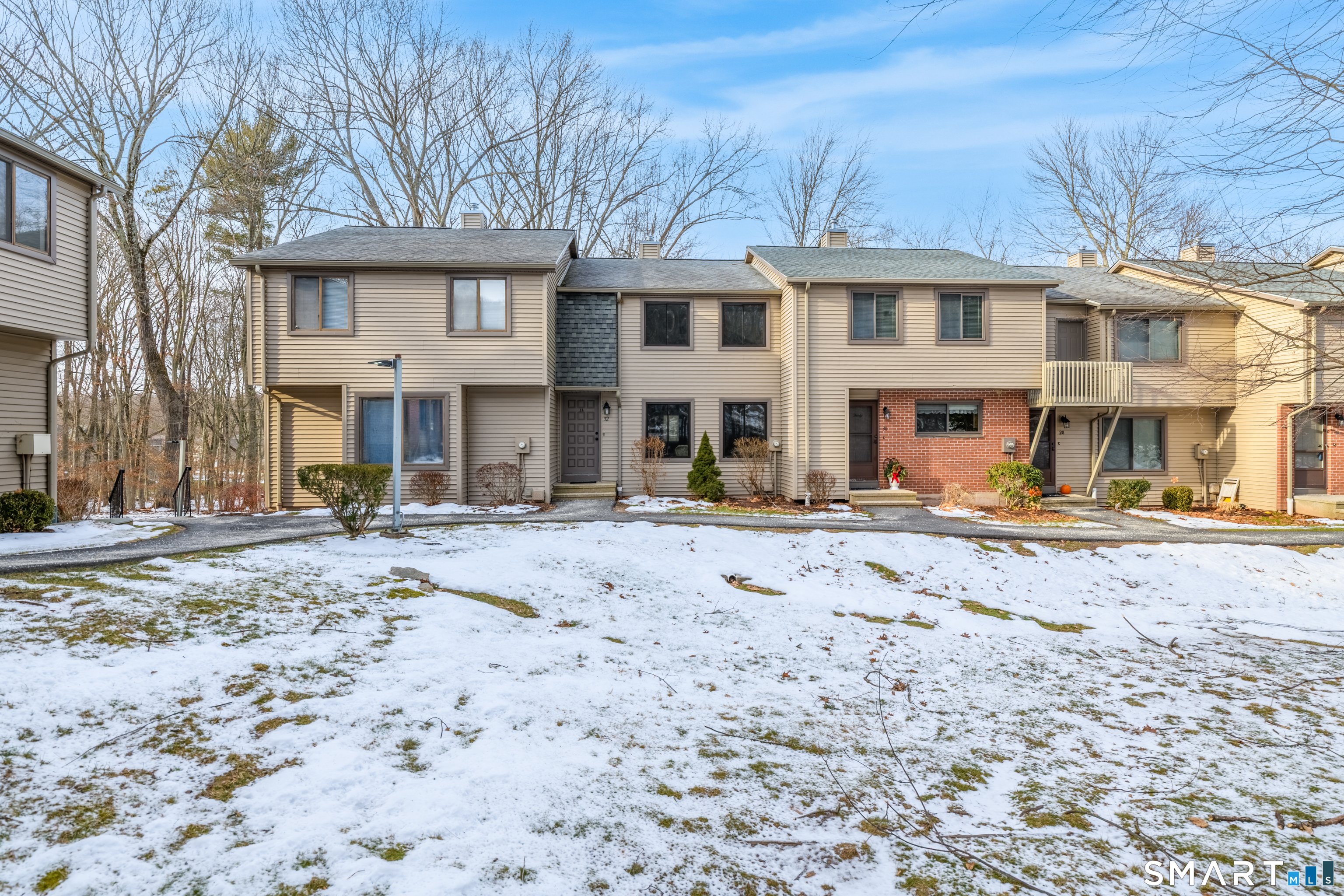 32 Conestoga Way, Unit 32 Glastonbury, CT 06033 - Photo 5 of 38 a front view of a building with a yard