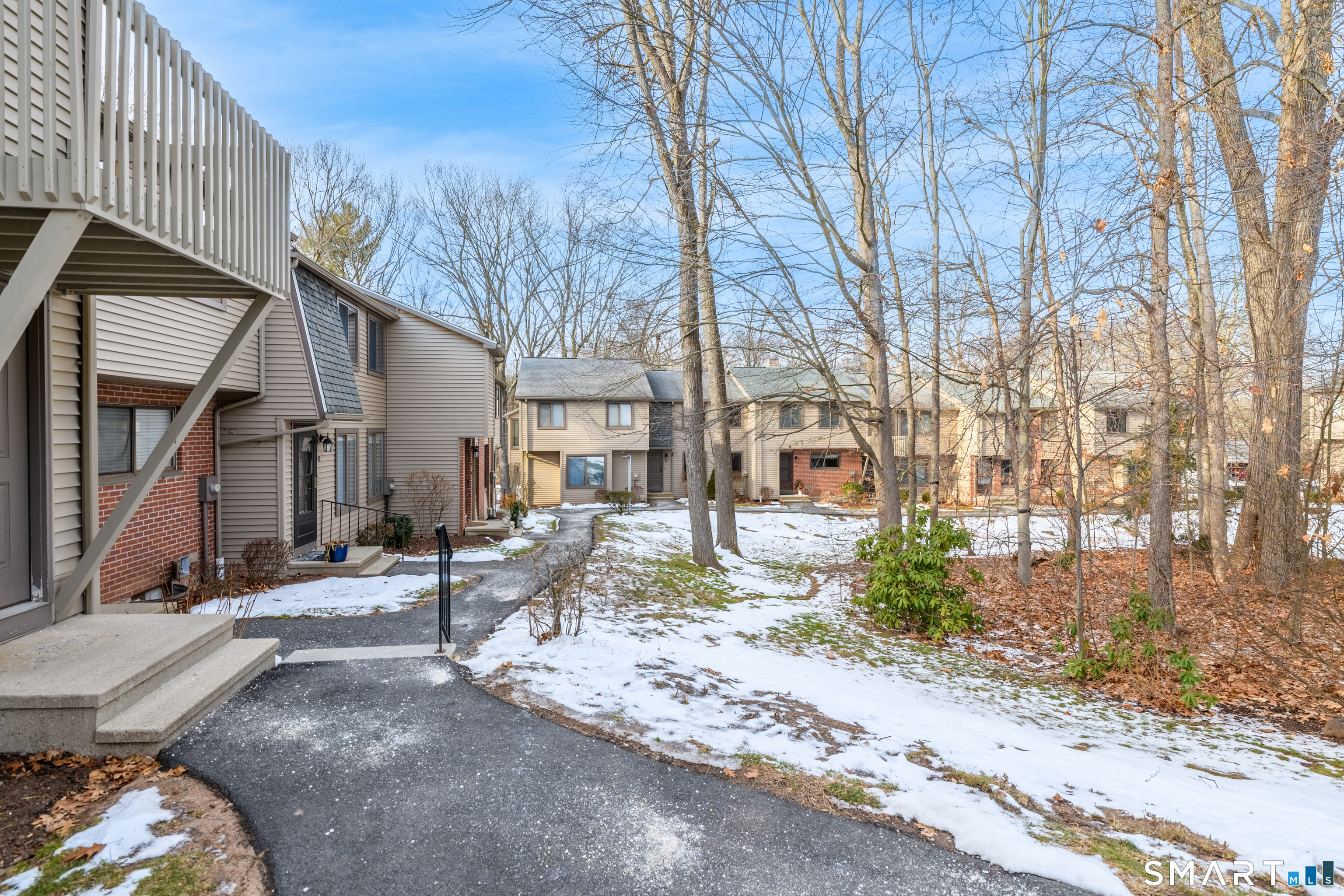 32 Conestoga Way, Unit 32 Glastonbury, CT 06033 - Photo 6 of 38 a view of a patio with a table and chairs under an umbrella