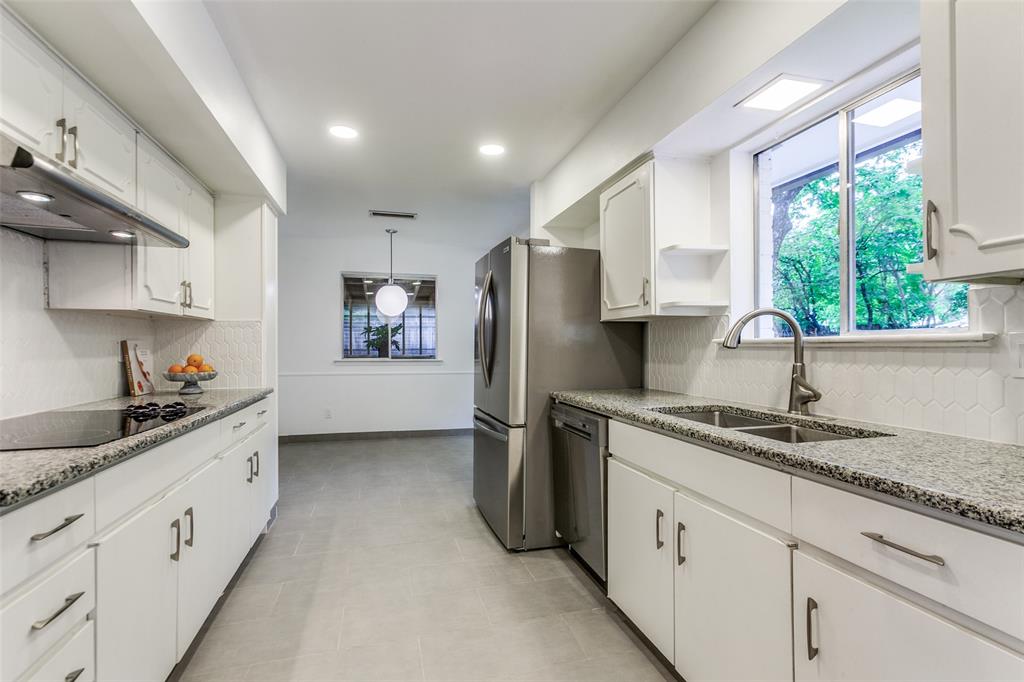 2718 Runningbrook Lane Dallas, TX 75228 - Photo 11 of 23 a kitchen with stainless steel appliances granite countertop a sink stove and refrigerator