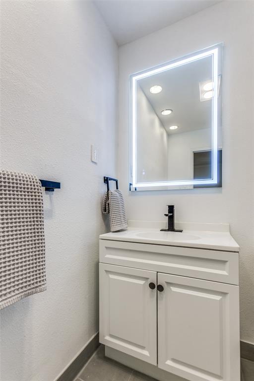 2718 Runningbrook Lane Dallas, TX 75228 - Photo 18 of 23 a bathroom with a sink vanity and a mirror