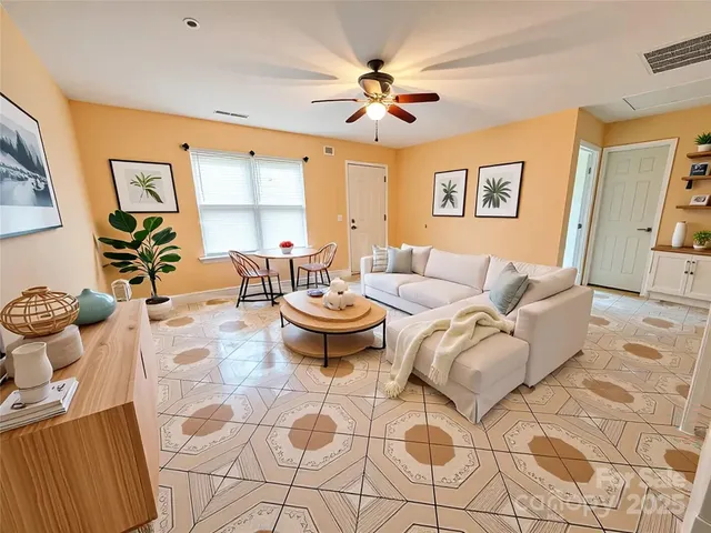 a living room with furniture and a large window