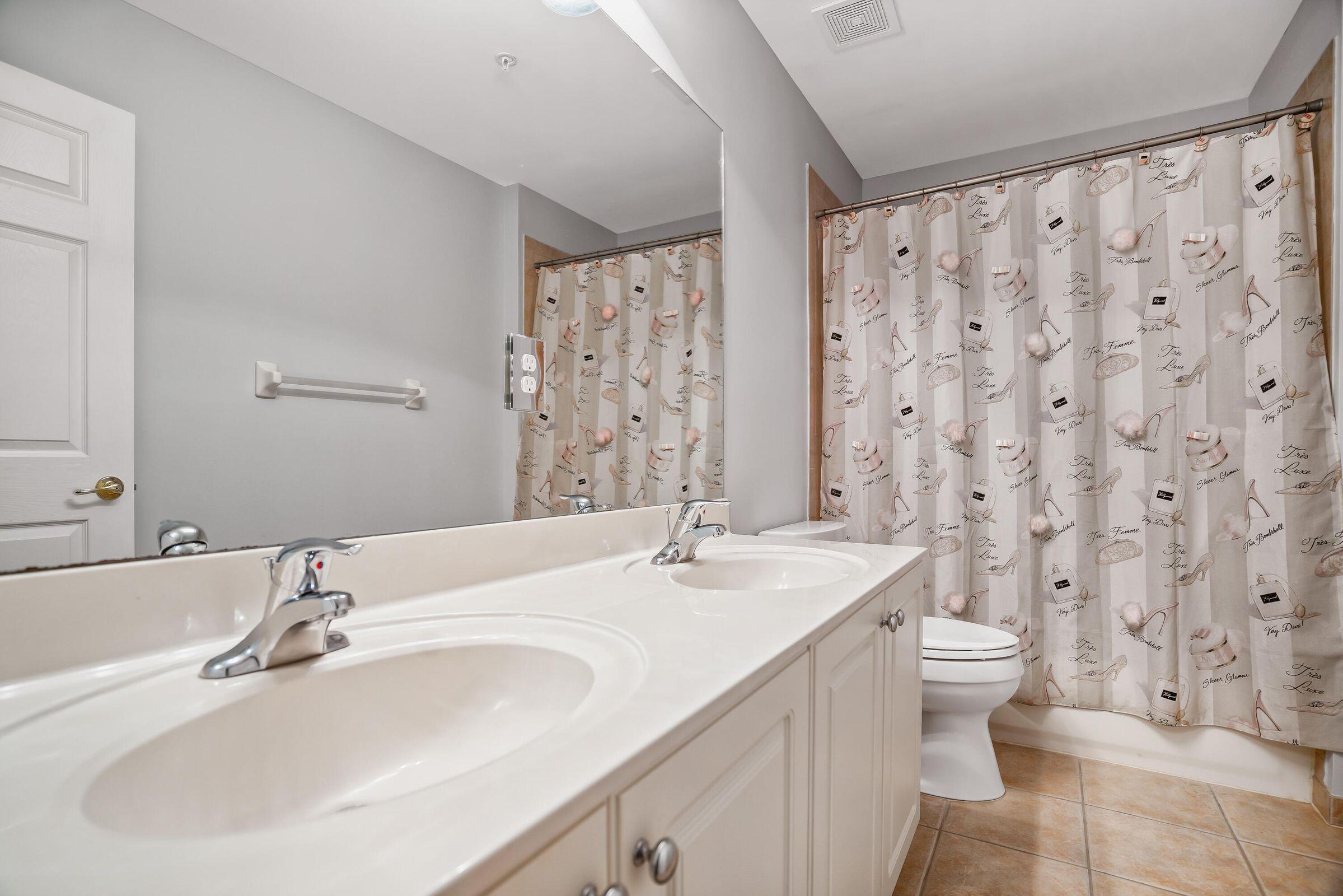7559 Spatterdock Drive Boynton Beach, FL 33437 - Photo 13 of 33 a bathroom with a sink and a large mirror