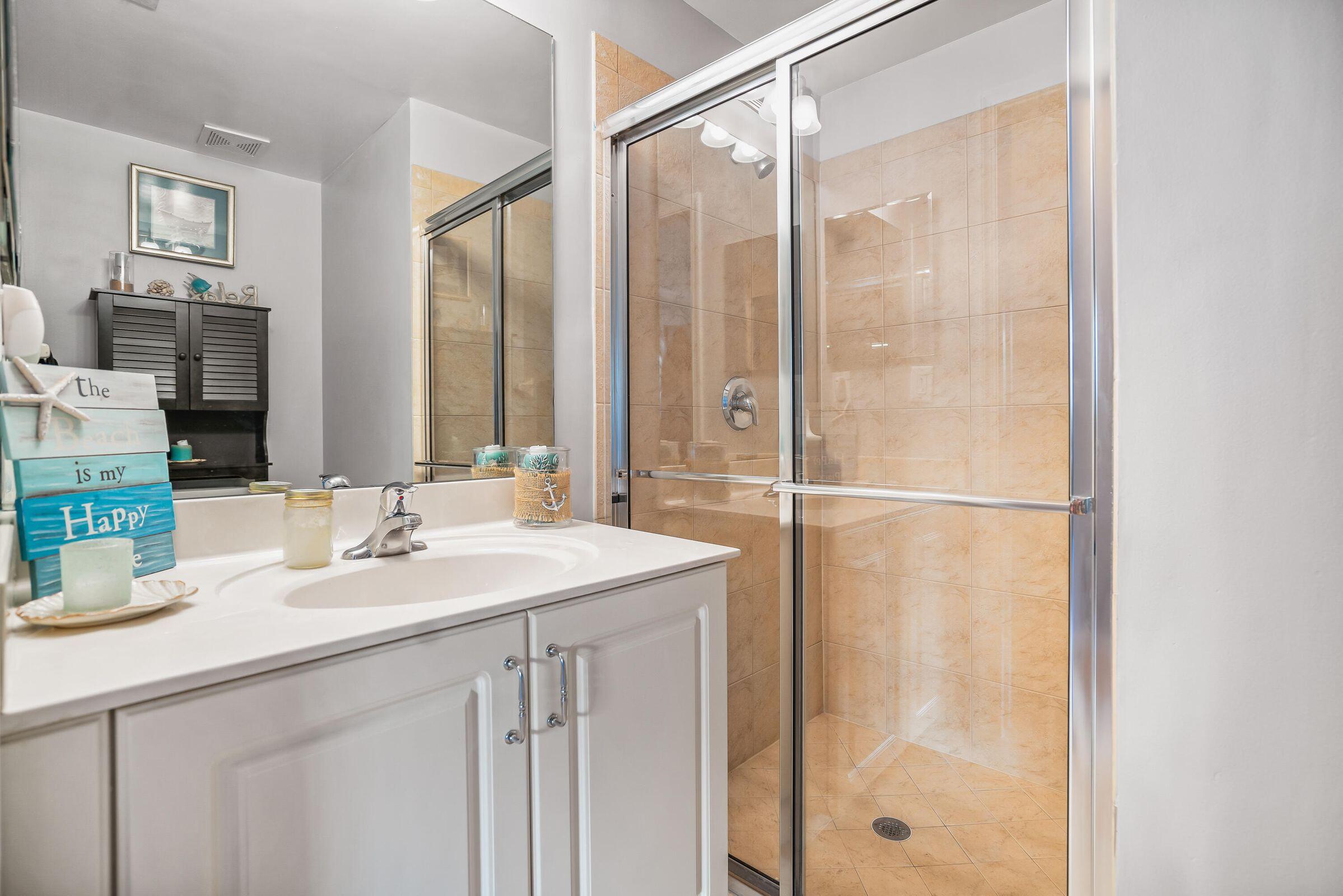 7559 Spatterdock Drive Boynton Beach, FL 33437 - Photo 16 of 33 a bathroom with a double vanity sink and a mirror