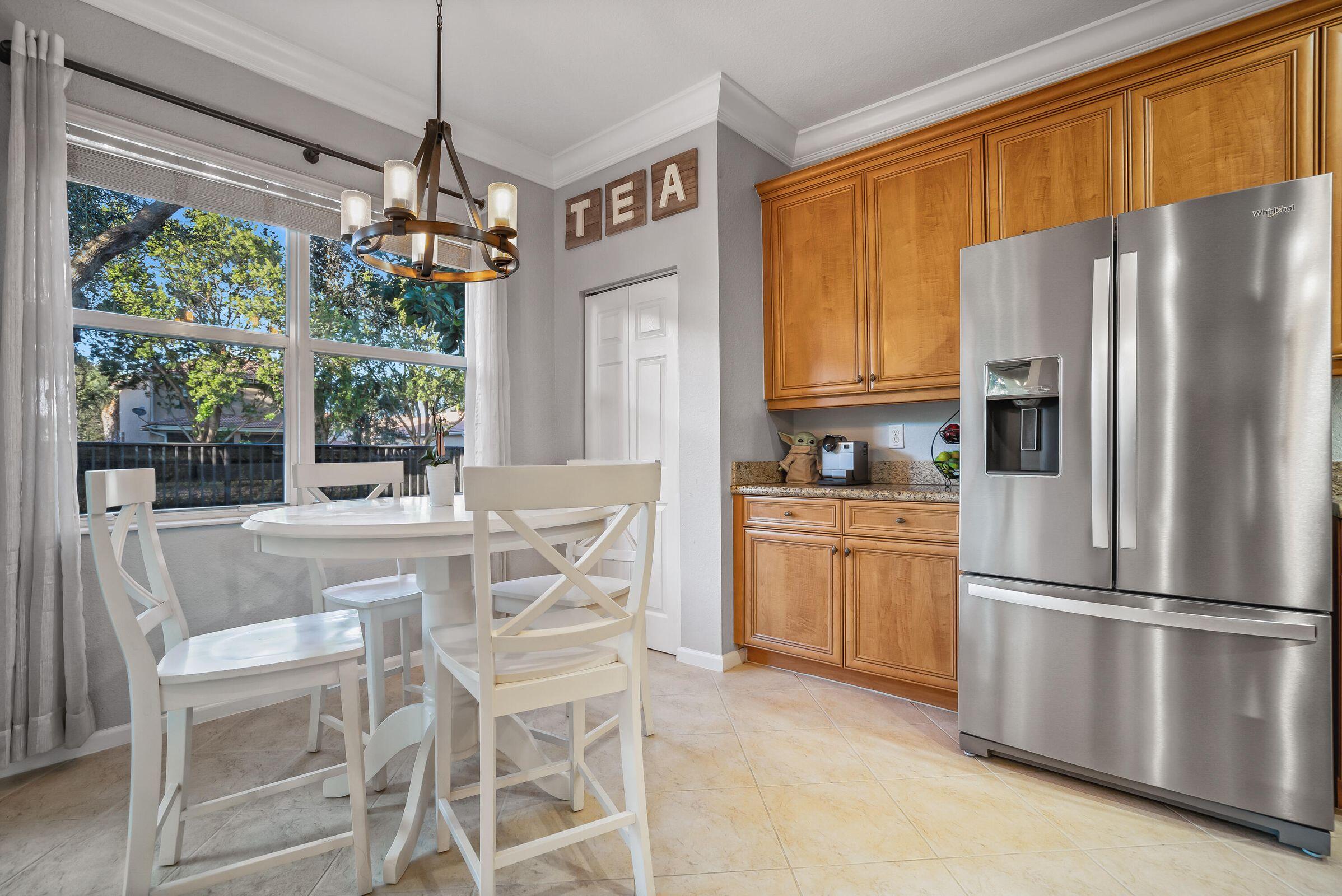 7559 Spatterdock Drive Boynton Beach, FL 33437 - Photo 9 of 33 a kitchen with stainless steel appliances granite countertop a refrigerator and a stove top oven