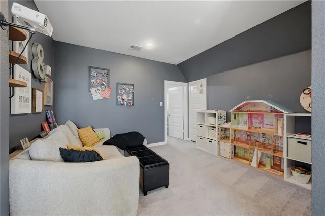 a living room with furniture and painting on the wall