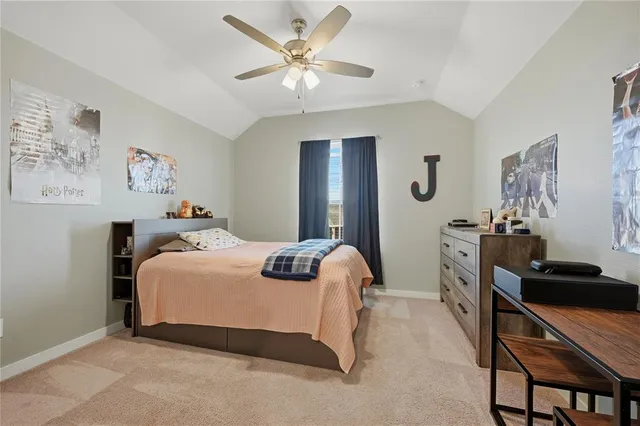 a bedroom with a bed window and a flat screen tv