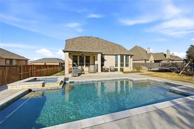 a view of swimming pool with a patio and a yard