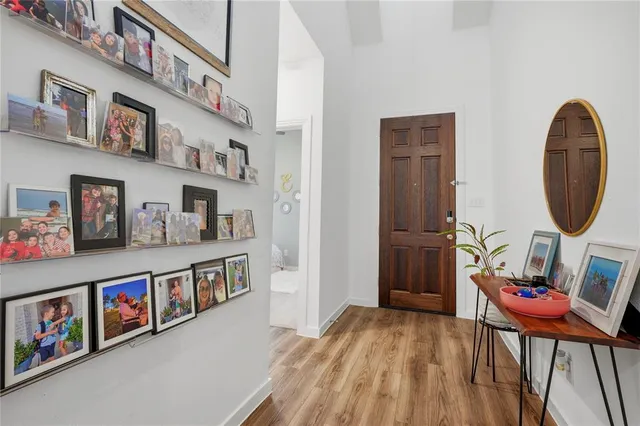 a view of entryway livingroom and hall with wooden floor
