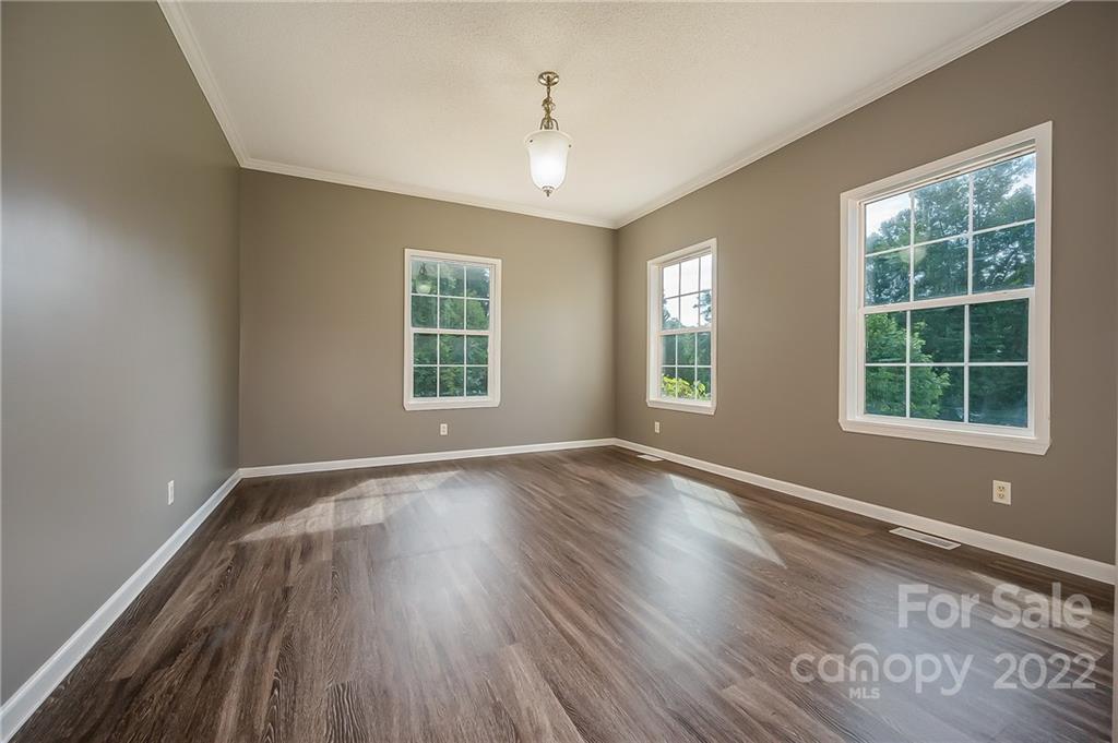 6410 Big Level Road Mill Spring, NC 28756 - Photo 15 of 32 a view of an empty room with wooden floor and a window