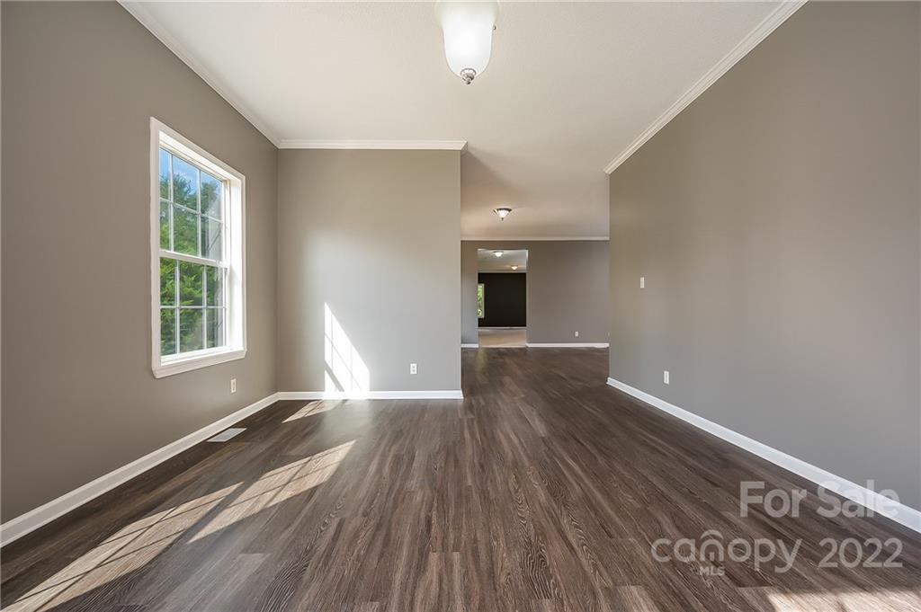 6410 Big Level Road Mill Spring, NC 28756 - Photo 16 of 32 wooden floor in an empty room with a window