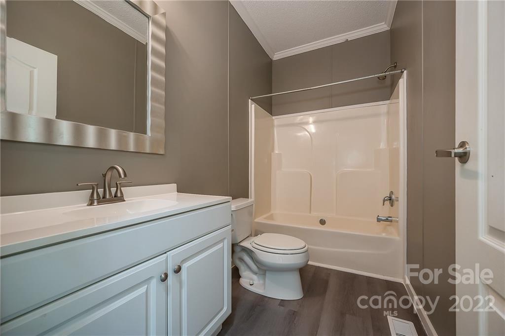 6410 Big Level Road Mill Spring, NC 28756 - Photo 25 of 32 a bathroom with a sink toilet and shower