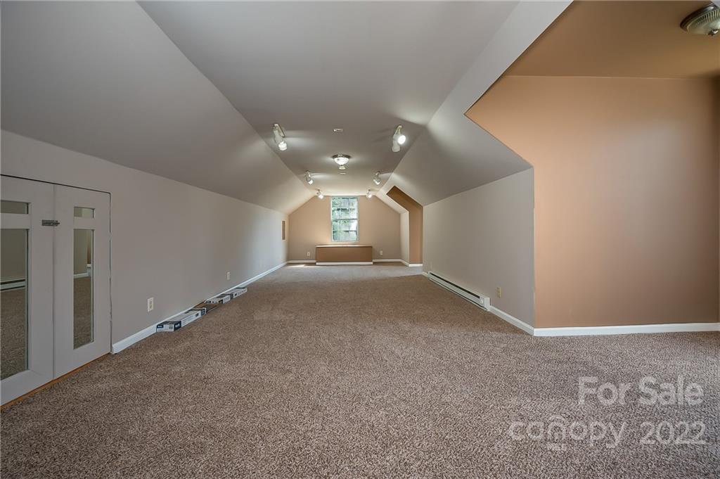 6410 Big Level Road Mill Spring, NC 28756 - Photo 29 of 32 a view of a big room with wooden floor and windows