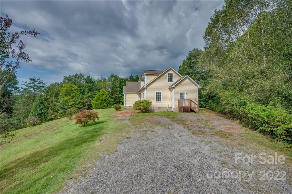 6410 Big Level Road Mill Spring, NC 28756 - Photo 32 of 32 a view of a house with backyard and garden