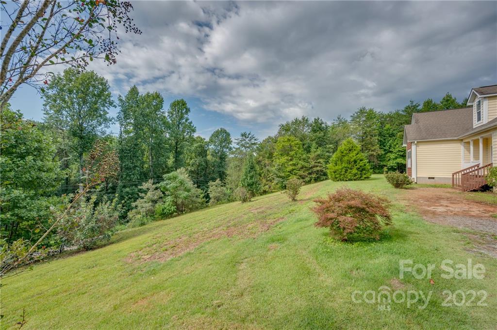 6410 Big Level Road Mill Spring, NC 28756 - Photo 5 of 32 a backyard of a house with lots of green space