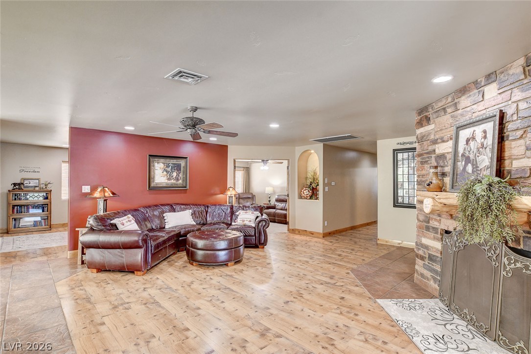 1950 Bowman Road Logandale, NV 89021 - Photo 10 of 81 A striking stone fireplace anchors this spacious living area with warm wood flooring.