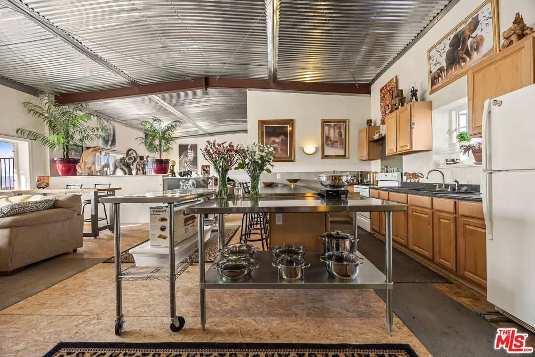 9025 Camp Rock Road Lucerne Valley, CA 92356 - Photo 21 of 54 a room with table chairs and white cabinets