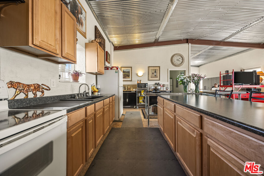 9025 Camp Rock Road Lucerne Valley, CA 92356 - Photo 22 of 54 a kitchen with stainless steel appliances granite countertop a sink and cabinets