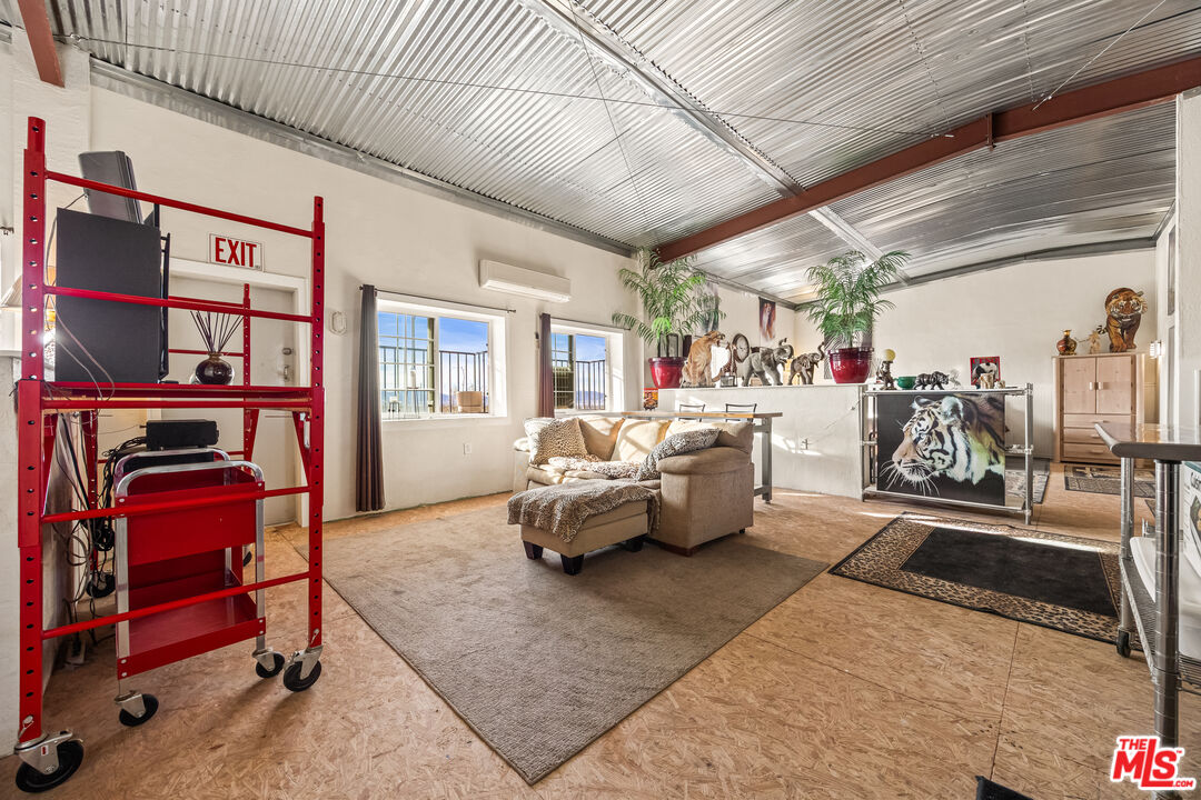9025 Camp Rock Road Lucerne Valley, CA 92356 - Photo 28 of 54 a living room with furniture gym equipment and a rug