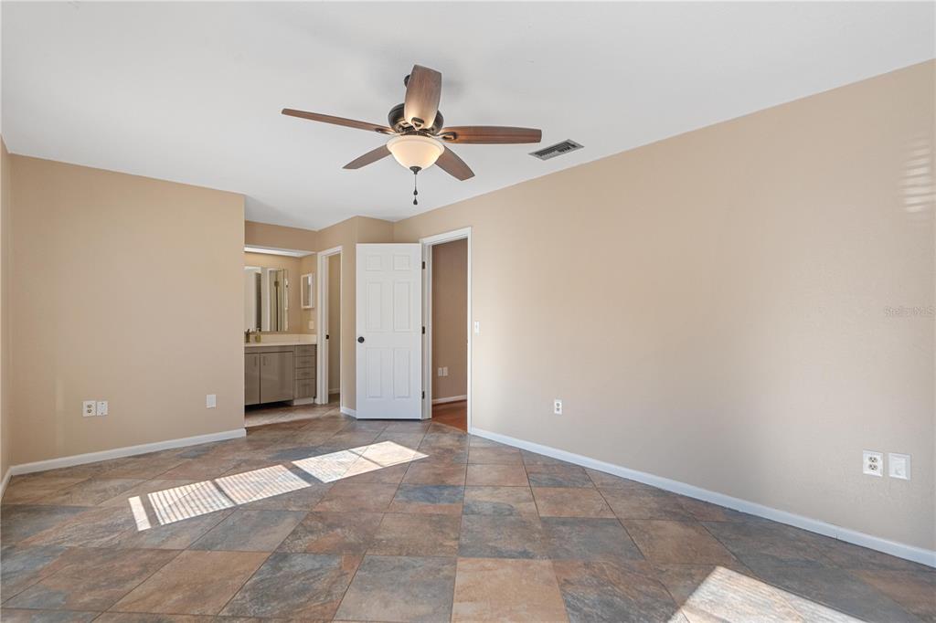 6007 Waycross Drive Spring Hill, FL 34606 - Photo 14 of 33 a view of a big room with wooden floor and chandelier fan