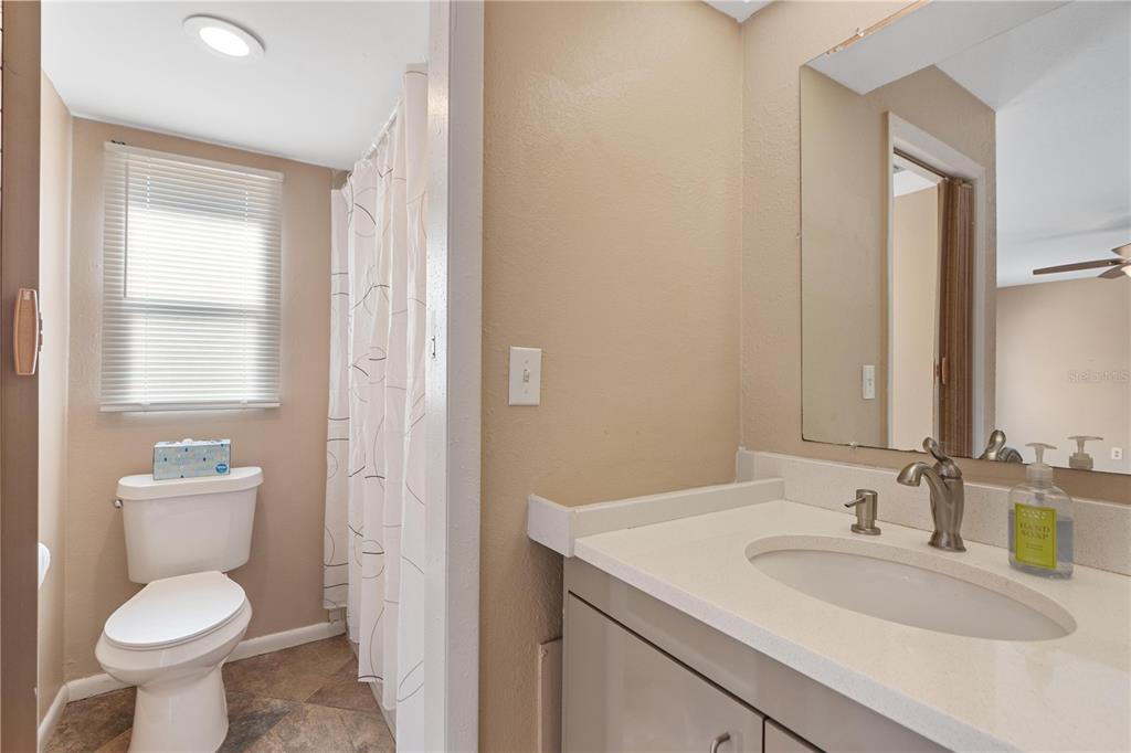 6007 Waycross Drive Spring Hill, FL 34606 - Photo 16 of 33 a bathroom with a toilet sink and mirror