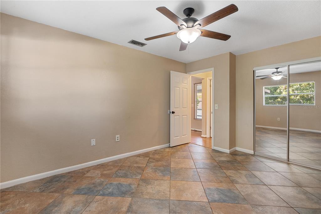 6007 Waycross Drive Spring Hill, FL 34606 - Photo 20 of 33 wooden floor in an empty room with a window