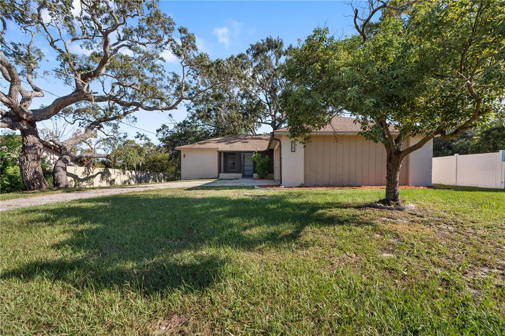 6007 Waycross Drive Spring Hill, FL 34606 - Photo 2 of 33 a front view of house with yard and trees