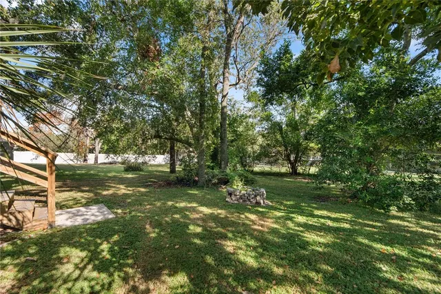 a backyard of a house with lots of green space and garden view