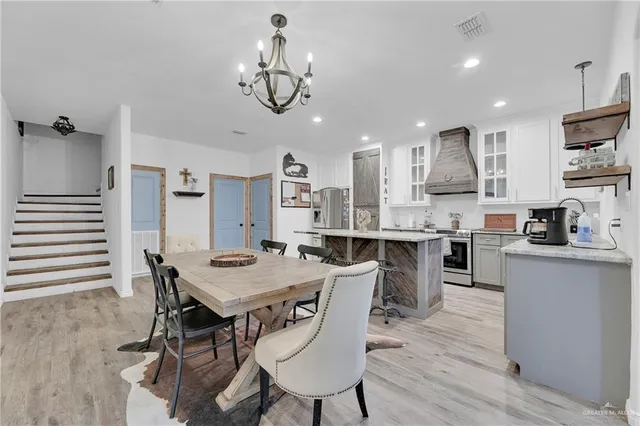 a view of a dining room with furniture kitchen and wooden floor