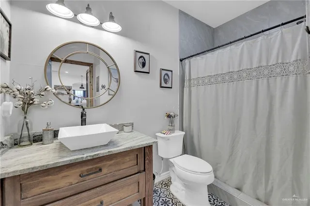 a bathroom with a toilet a sink and a mirror