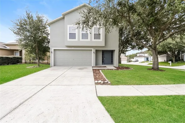 a front view of a house with a yard