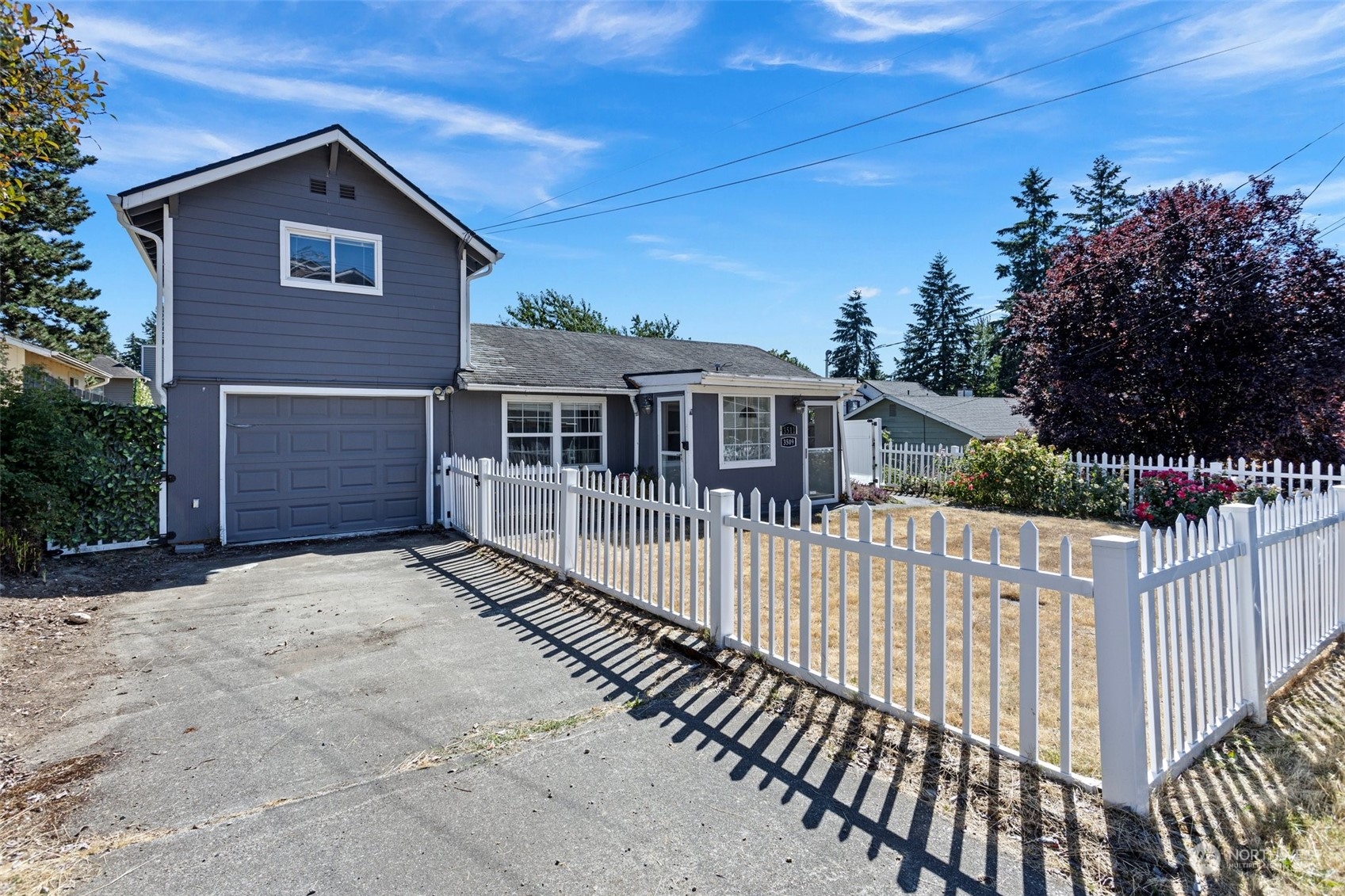 3509 Northeast 6th Street Renton, WA 98056 - Photo 1 of 26 a front view of a house with a yard